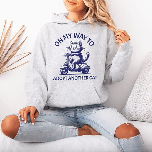 Featuring a playful illustration of a determined cat riding a scooter, this hoodie is the purr-fect way to announce your cat-loving intentions to the world.